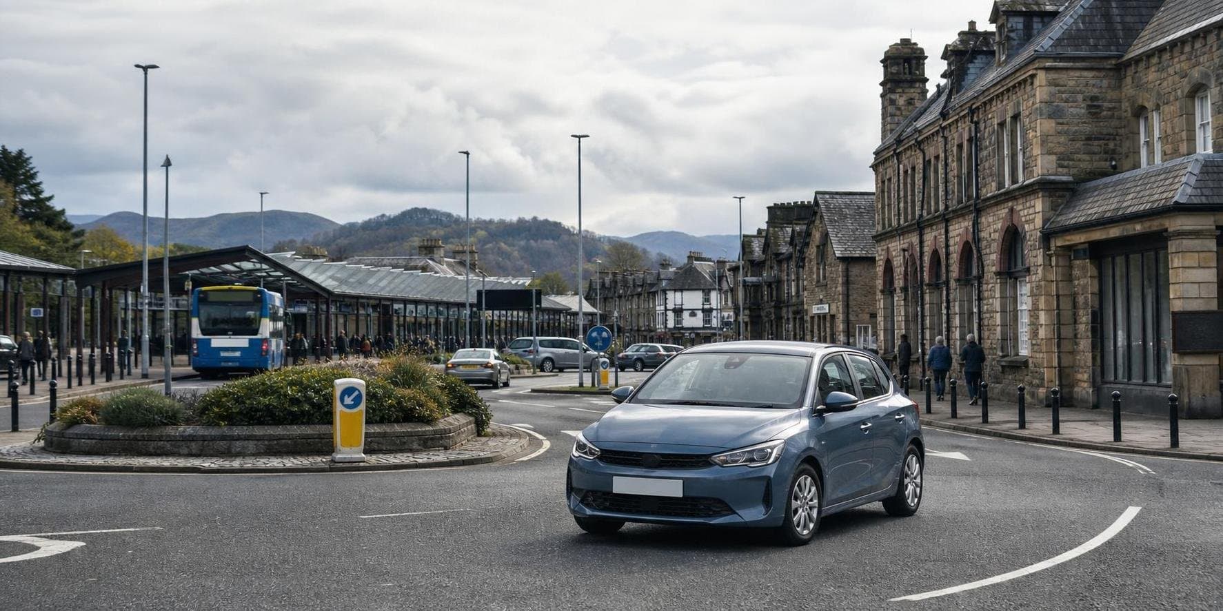 Compact hire car on a local road heading through Workington